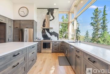 Kalispell house for rent - A modern kitchen with wooden cabinets and a marble backsplash.
