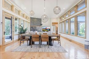 Kalispell house for rent - A modern dining room with a large table and chairs.