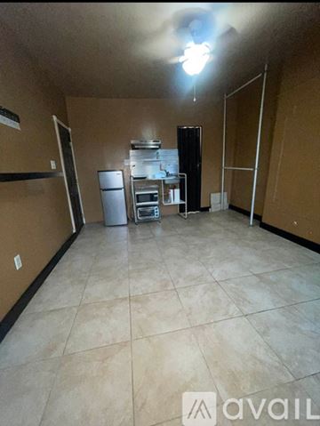 Brooklyn apartment for rent - A kitchen area with a refrigerator, microwave, and oven.