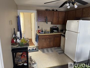 Penn Yan apartment for rent - A kitchen with a white refrigerator and wooden cabinets.