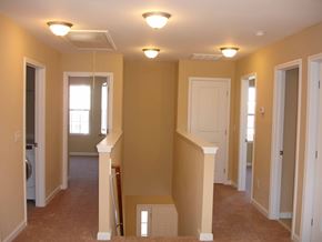 Durham house for rent - A hallway with a washer and dryer in the doorway.