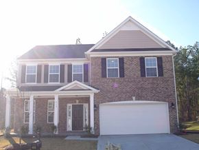 Durham house for rent - A two-story house with a garage door and a brick facade.
