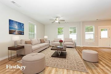 Antioch house for rent - A living room with a couch, a coffee table, and a painting on the wall.