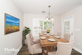 Maylene house for rent - A dining room with a wooden table set for six.