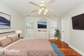 Maylene house for rent - A bedroom with a bed, dresser, and a ceiling fan.