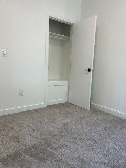 Edmonton apartment for rent - A white door is open to a room with a carpeted floor.