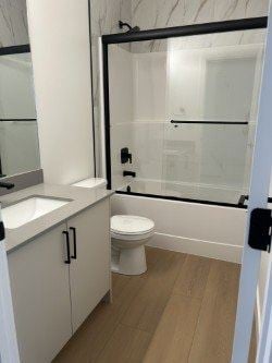 Edmonton apartment for rent - A white toilet sits in a bathroom with a sink and mirror.