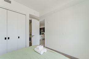 Dania Beach apartment for rent - A white bedroom with a bed and a white towel on it.