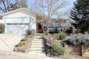 Boulder Creek apartment for rent - A house with a white garage door and a brown fence.