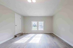 Jacksonville house for rent - A room with a wooden floor and a window letting in sunlight.