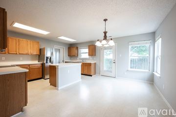 Fishers house for rent - A kitchen with wooden cabinets and a white island.