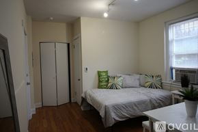 Chicago apartment for rent - A bedroom with a bed, a wardrobe, and a window.