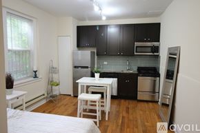 Chicago apartment for rent - A kitchen with black cabinets and stainless steel appliances.