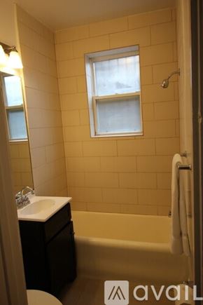 Chicago apartment for rent - A bathroom with a toilet, sink, and bathtub.