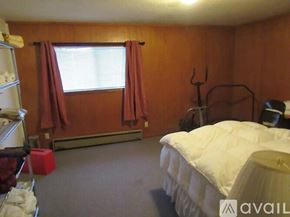 Fall River Mills apartment for rent - A bedroom with a white bed and a window with red curtains.