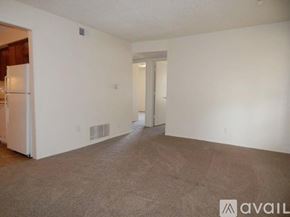 Topeka apartment for rent - A room with carpeted floor and white walls with a doorway leading to another room.