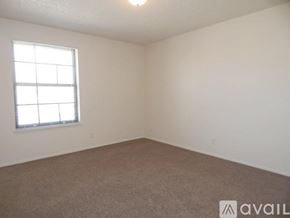 Topeka apartment for rent - A room with a carpeted floor and a window with blinds.
