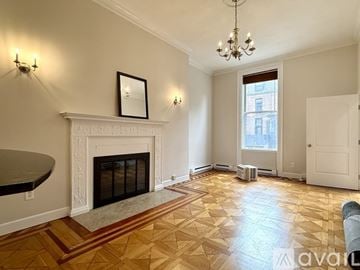 Boston apartment for rent - A living room with a fireplace and a painting on the wall.