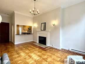 Boston apartment for rent - A kitchen with wooden cabinets and black countertops.