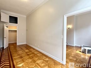 Boston apartment for rent - A bedroom with a large bed and a painting on the wall.