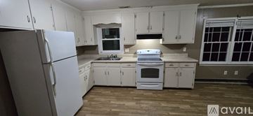 Fremont house for rent - A kitchen with white cabinets and appliances is available for rent.