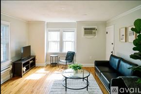 Des Moines apartment for rent - A black leather couch with a potted plant on the side.