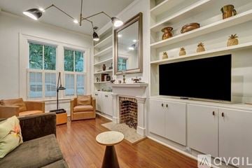 Savannah house for rent - A living room with a fireplace and a television on the wall.