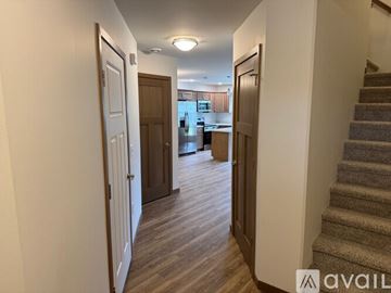 Marshfield house for rent - A kitchen with dark wood cabinets and stainless steel appliances.