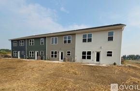 Marshfield house for rent - A two-story house with a grey and green exterior is shown.
