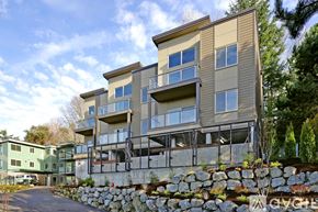 Mercer Island apartment for rent - A modern apartment building with a stone wall in front.
