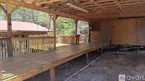 Marion apartment for rent - A wooden deck with a roof and railings is under construction.