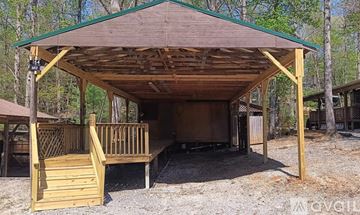 Marion apartment for rent - A wooden pavilion with a green roof and a sign that reads "EXIT" is surrounded by trees.