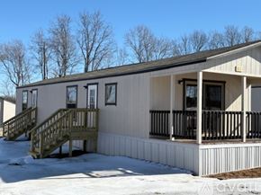 Bells house for rent - A room with wooden flooring and a door on the right side.