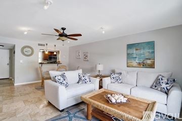 Dunedin apartment for rent - A living room with a white couch and a painting on the wall.