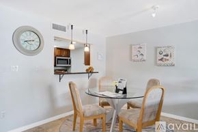Dunedin apartment for rent - A dining room with a glass table and chairs.