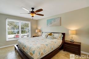 Dunedin apartment for rent - A bedroom with a large bed and a ceiling fan.