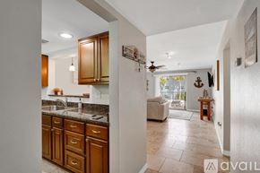 Dunedin apartment for rent - A kitchen with wooden cabinets and a countertop with a sink.