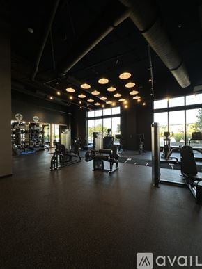 Oakland Park apartment for rent - A gym with various exercise equipment and a large window letting in natural light.