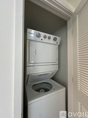 Oakland Park apartment for rent - A white Whirlpool dishwasher and washing machine are stacked in a small space.