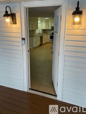 Centre Hall house for rent - A white door with a glass window leading to a kitchen.