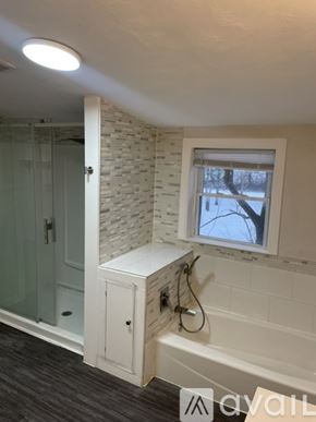 Centre Hall house for rent - A bathroom with a window showing trees outside.