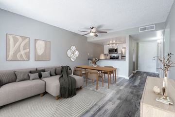 Mesa apartment for rent - A living room with a grey couch and a wooden table.