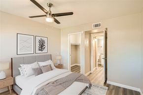 Mesa apartment for rent - A bedroom with a bed, a ceiling fan, and a nightstand.