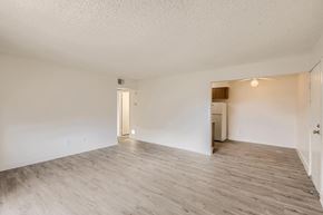 Mesa apartment for rent - A spacious room with wooden flooring and white walls.