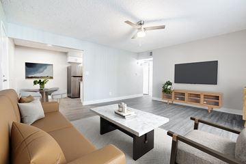 Mesa apartment for rent - A living room with a brown couch and a television on the wall.