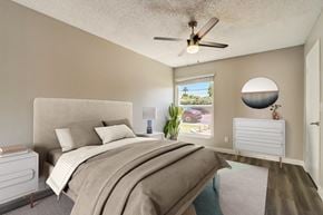 Phoenix apartment for rent - A bedroom with a large bed and a ceiling fan.