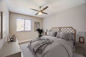 Glendale apartment for rent - A bedroom with a large bed and a ceiling fan.