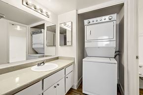 Glendale apartment for rent - A BBQ grill is on a patio with a blue chair and table.