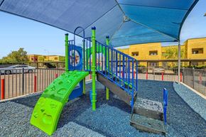 Glendale apartment for rent - A playground with a green slide and blue and green play equipment.
