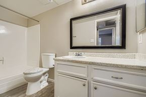 Phoenix apartment for rent - A spacious room with a ceiling fan and tile flooring.
